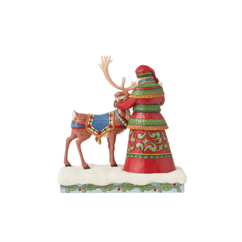 Santa Standing with a Reindeer Figurine